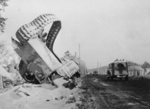 A 90th Division ambulance passes by a knocked out German tank on the road to Bastogne, Belgium - January 22, 1945. (Photo by SGT. P.E. Anders, U.S. Army Signal Corps, courtesy National Archives)