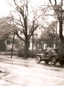 A 5th Division jeep rolls down an Albion side street.