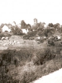 5th Division tents and trucks cover a field outside Albion.  Note the courthouse in the background.