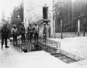 At Flossenburg Concentration Camp, members of the 90th and 97th Infantry Divisions inspect a ramp system used to transport dead bodies from the camp's upper level to the lower lever crematorium for incineration - April 1945. (U.S. Army Signal Corps Photo, Courtesy National Archives)