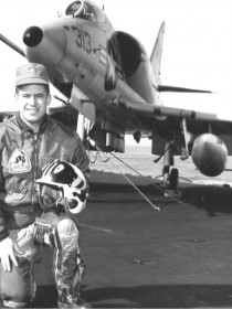 Scotty Greiling, kneeling on the deck of the USS Kitty Hawk, flew the A-4 on a fleet tour prior to the Vietnam War.