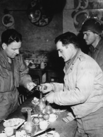 90th Infantry Division soldier, Charles Cook, shows baseball great, Mel Ott, a souvenir pistol he picked up along the German front. (U.S. Army Signal Corps Photo, Courtesy National Archives)