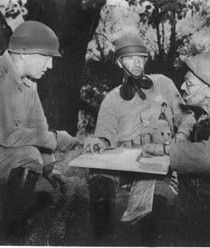 Colonel Harry "Paddy" Flint (right) discusses strategy with his friend and commander, General George Patton (left) along with another officer. (Photo Courtesy Creative Commons)