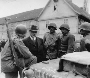 With the mayor of Oberhausen, Germany, 90th Infantry Division soldiers go over a list of demands regarding the city's surrender - April 1945. (U.S. Army Signal Corps Photo, Courtesy National Archives)