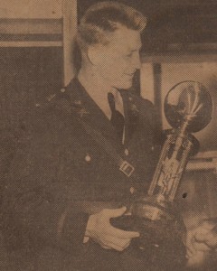 Coach Sandefur holds the V Army Corps Championship Trophy.