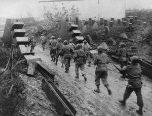 Near Habscheid, Germany, soldiers from Company E, 358th Infantry, 90th Infantry Division, push through the dragon's teeth of the Siegfried Line on their way to the front - February 12, 1945. (U.S. Army Signal Corps Photo, Courtesy National Archives)
