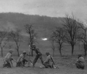 90th Infantry Division mortar crew fires high explosive (HE) shells into fortified German positions along the Moselle River, near Halstroff, France - December 3, 1944. (U.S. Army Signal Corps Photo, Courtesy National Archives)