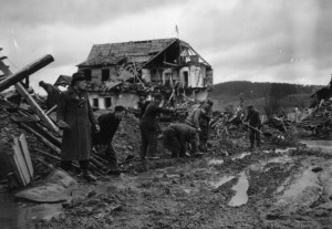 Former Polish POWs, recently liberated by the 90th Infantry Division, use debris to fill in a well-traveled American route to the front lines near Kelberg, Germany - March 1945. (U.S. Army Signal Corps Photo, Courtesy National Archives)