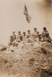 Soldiers of the 152nd Infantry raise the Stars and Stripes over Woodpecker Ridge following their victory on Luzon.
