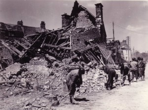 The ruin that war leaves behind. American infantrymen help clear debris from the streets of recently liberated, Saint Sauveur, France - June 19, 1944. (U.S. Army Signal Corps Photo, Courtesy National Archives)
